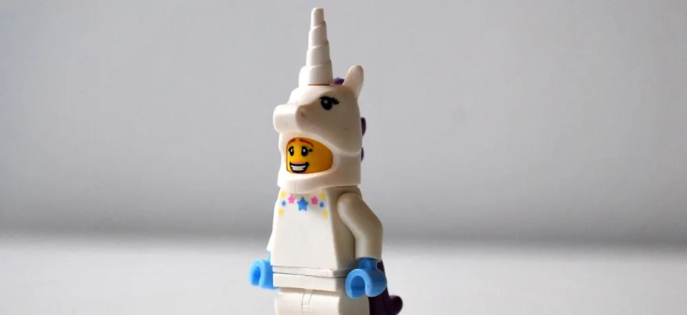 A Lego figure in a unicorn costume