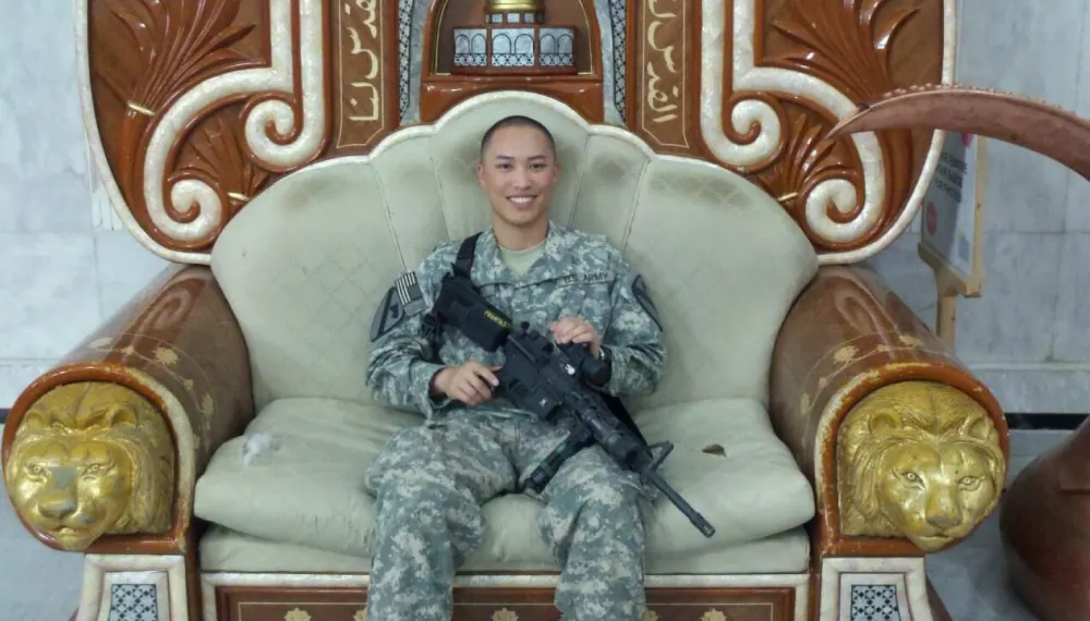 Khoa in a U.S. Army uniform sitting in an ornate chair